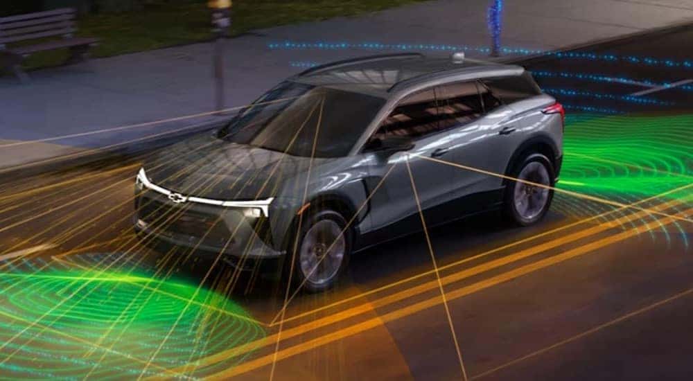 Simulated safety lines are shown being used by a silver 2024 Chevy Blazer EV.