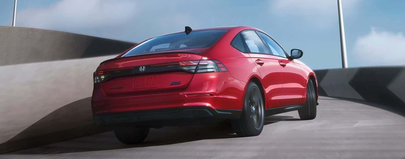 Rear view of a red 2026 Honda Accord Sport-L Hybrid.