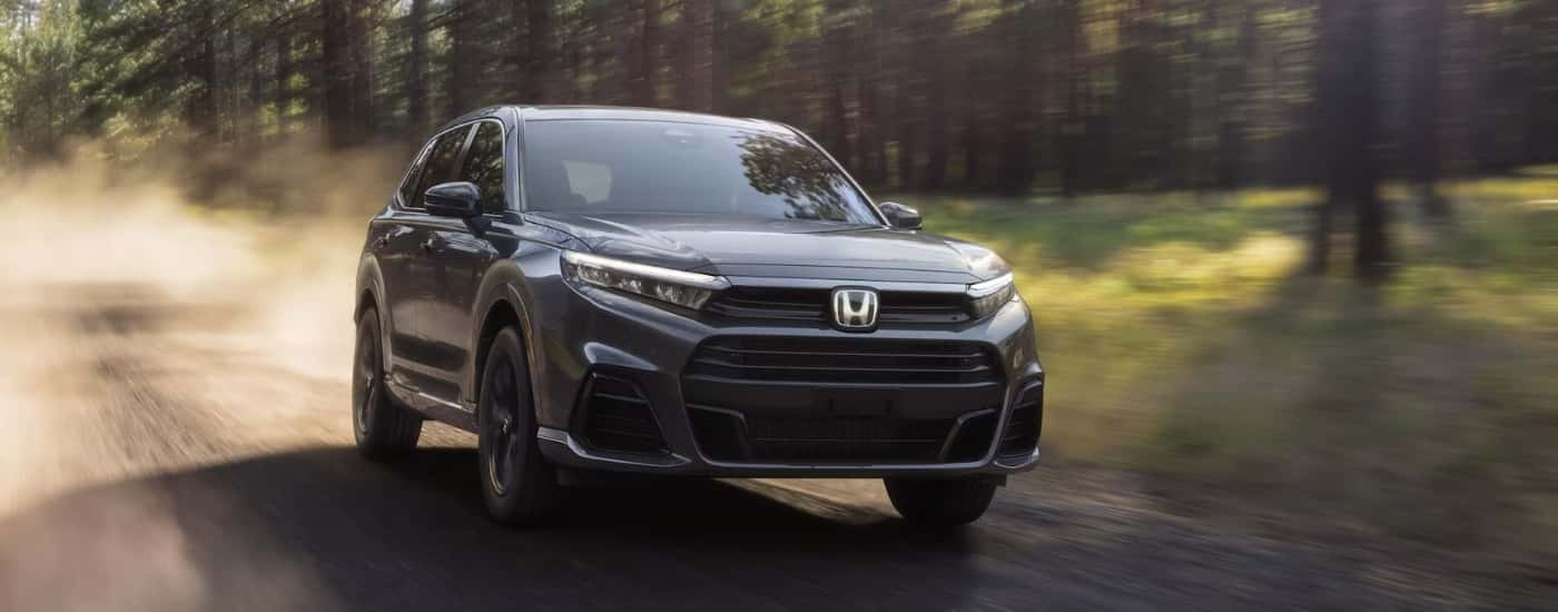 Black 2025 Honda CR-V driving down a dusty trail