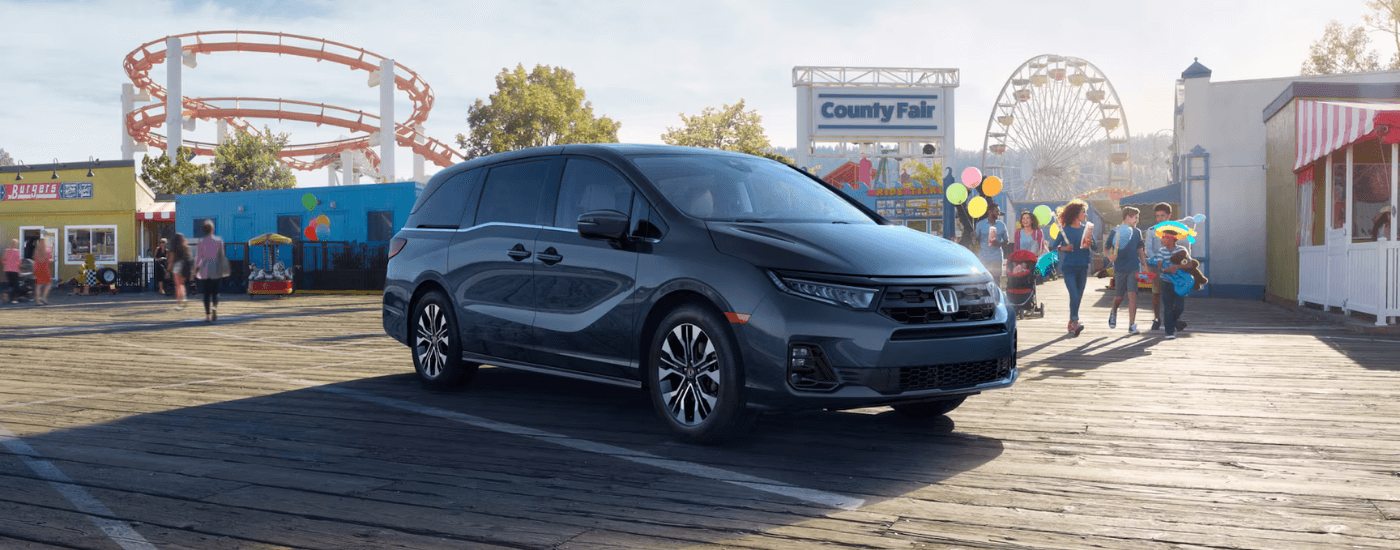 Grey 2026 Honda Odyssey parked in front of a fair