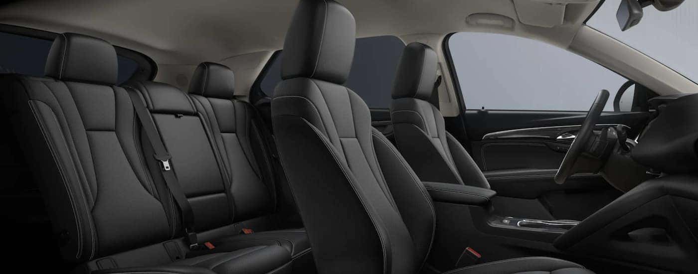 The black interior of a 2023 Buick Envision shows two rows of seating.