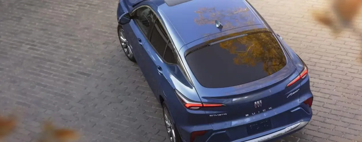 A blue 2024 Buick Envista is shown from above while parked in a brick driveway.