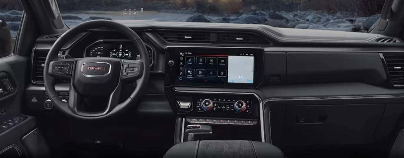 The black interior and dash of a 2024 GMC Sierra 1500 is shown.