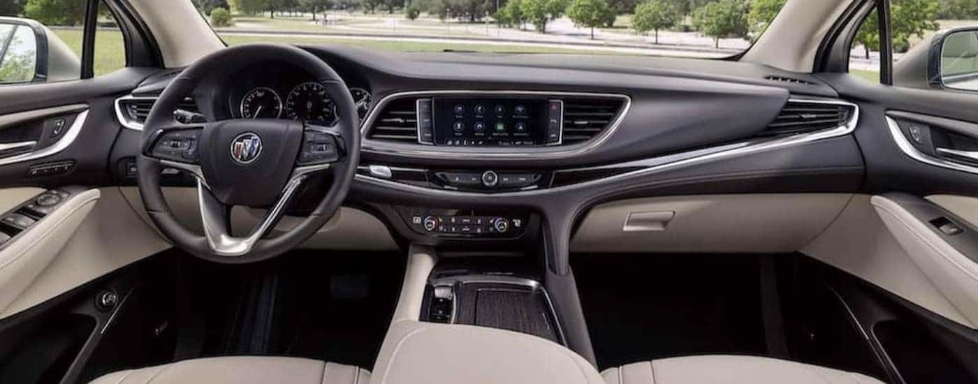 The black and white interior and dash of a 2023 Buick Enclave is shown.