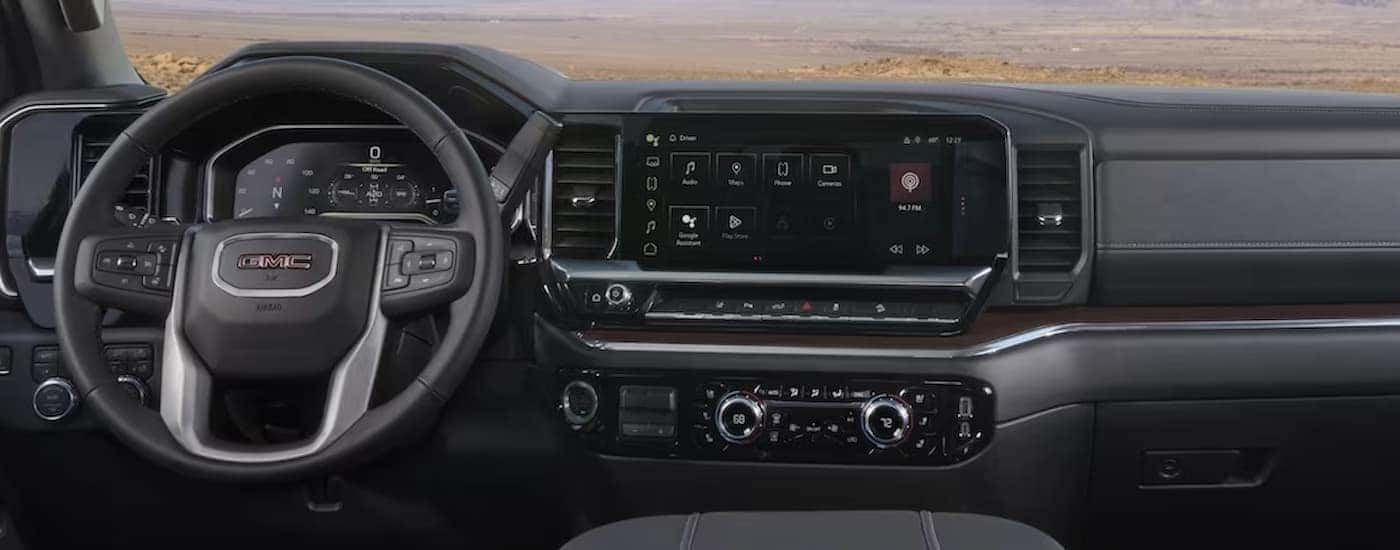 The gray interior and dash of a 2024 GMC Sierra 2500 HD is shown.