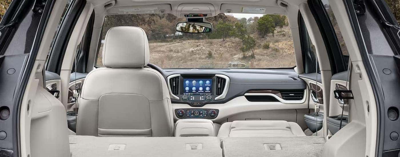 The white and gray interior and dash of a 2024 GMC Terrain is shown.