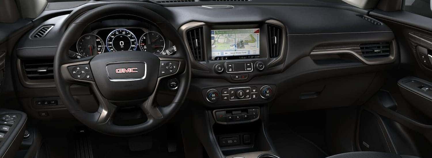 The black interior and dash of a 2024 GMC Terrain is shown.