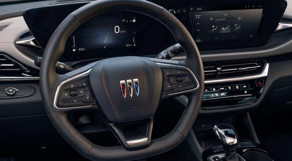 The black steering wheel and interior of a 2024 Buick Envista is shown.