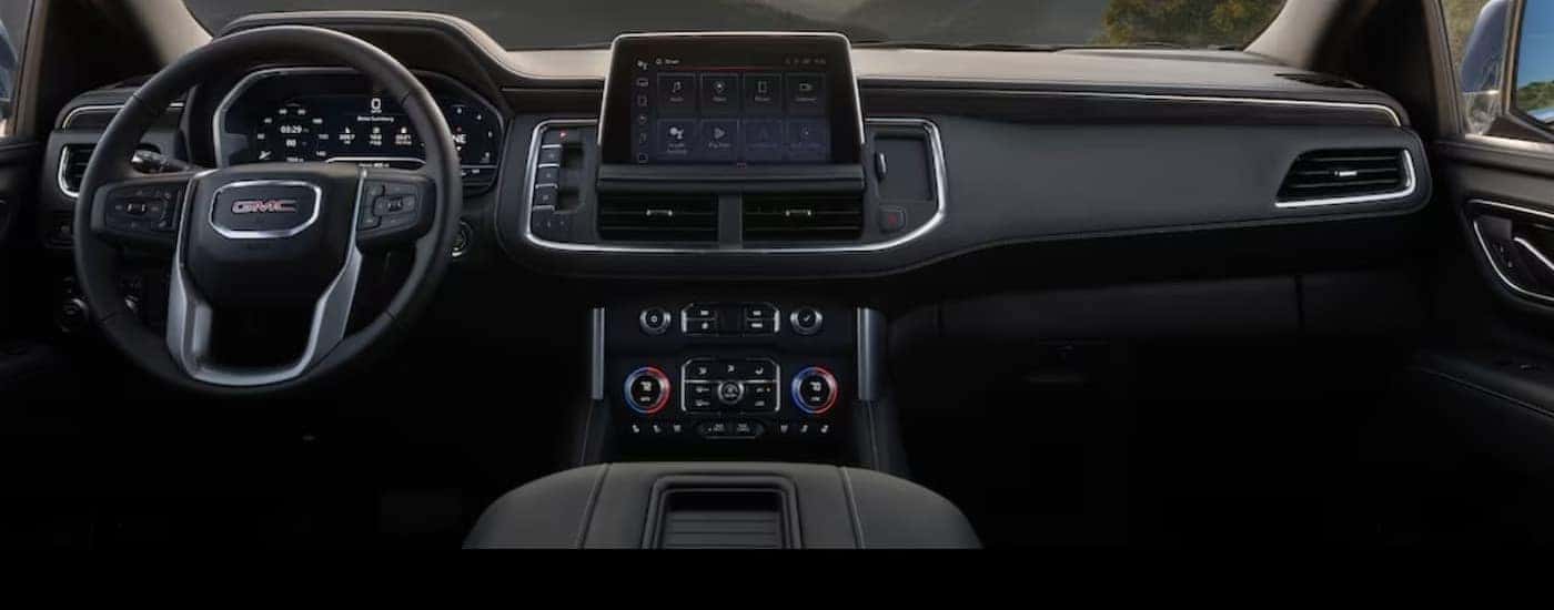 The black interior and dash in a 2024 GMC Yukon is shown.