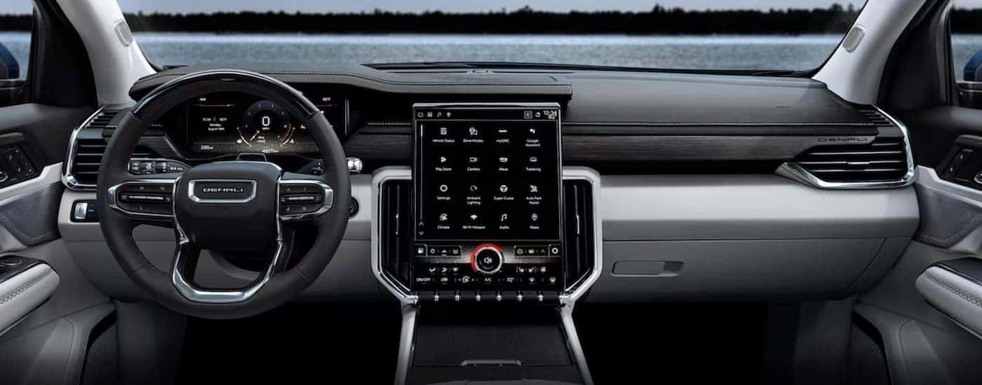 The black and gray interior and dash in a 2024 GMC Acadia is shown.