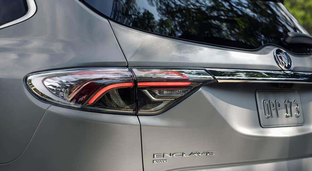 A close up of the rear taillight on a silver 2024 Buick Enclave.