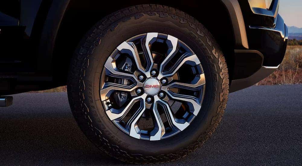 A close up of the rim on a black 2024 GMC Canyon.