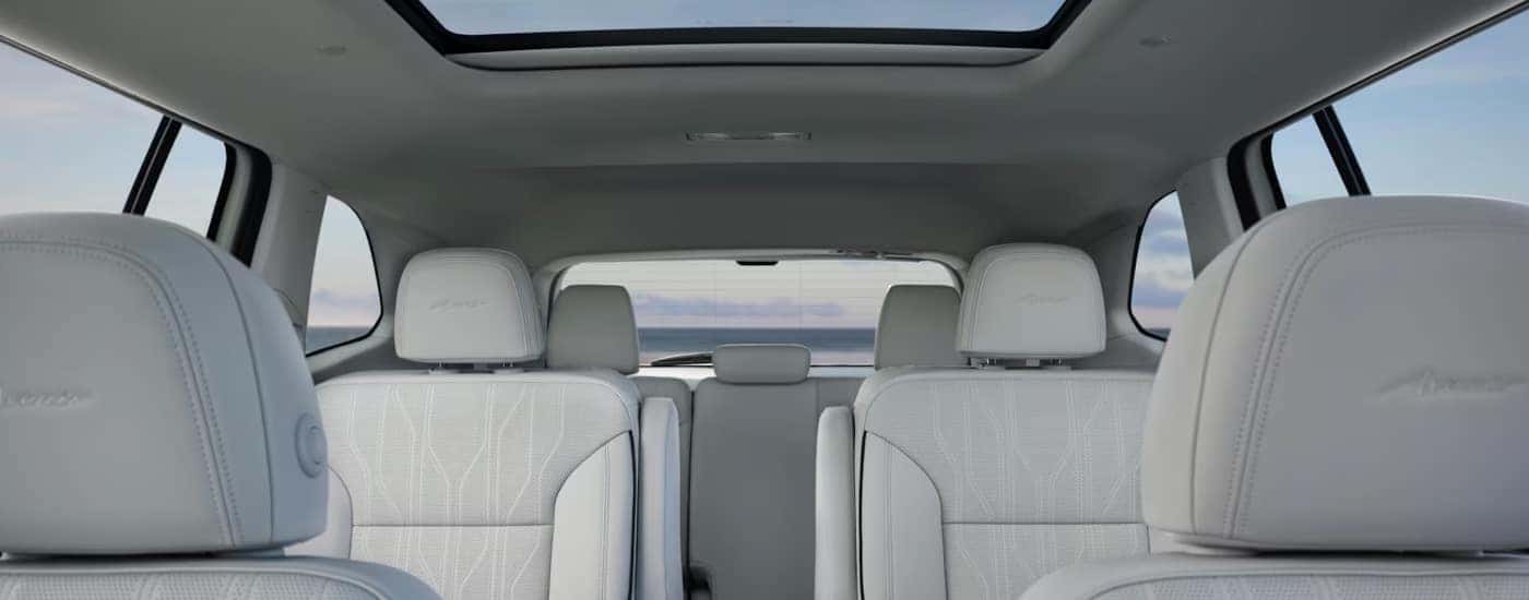 Beige upholstery and the moonroof in a 2025 Buick Enclave Avenir.