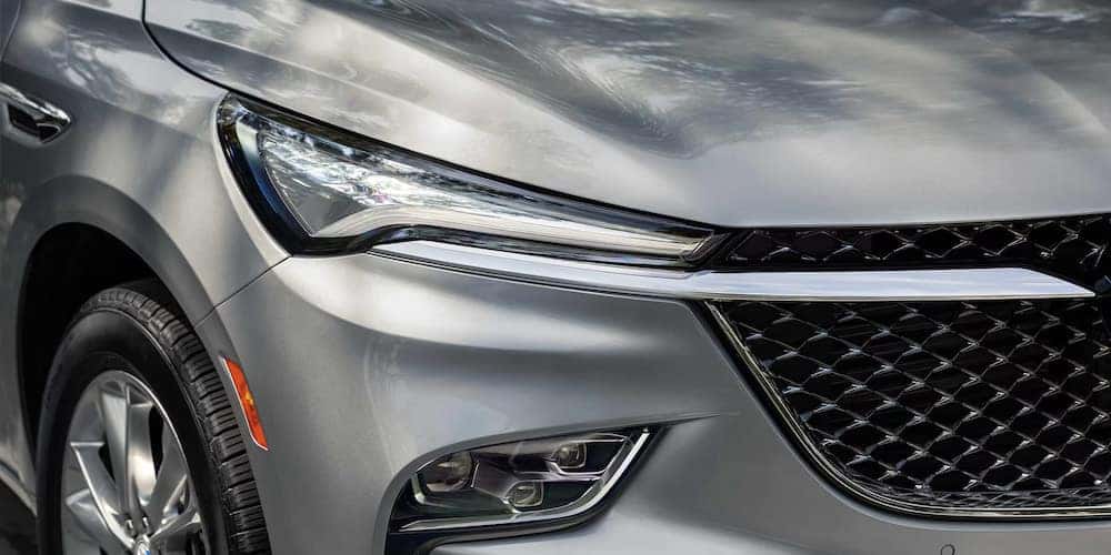 A close-up of the grille on a silver 2024 Buick Enclave Avenir.