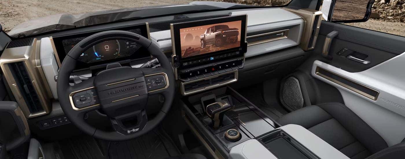 The cabin, steering wheel, and infotainment screen in a 2024 GMC Hummer EV Pickup.