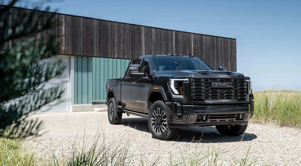 A black 2024 GMC Sierra 2500 HD Denali is shown from the front at an angle.