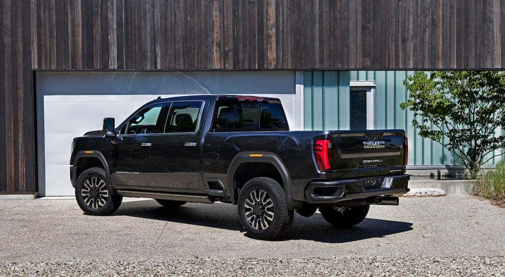 A black 2024 GMC Sierra 2500 HD Denali is shown from the side.