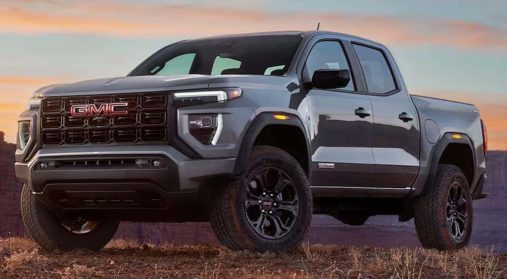 A gray 2024 GMC Canyon Elevation is shown parked off-road.