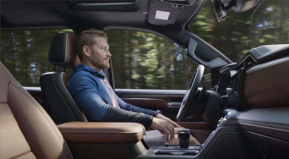 A person is shown using Super Cruise in a 2025 GMC Sierra 1500.