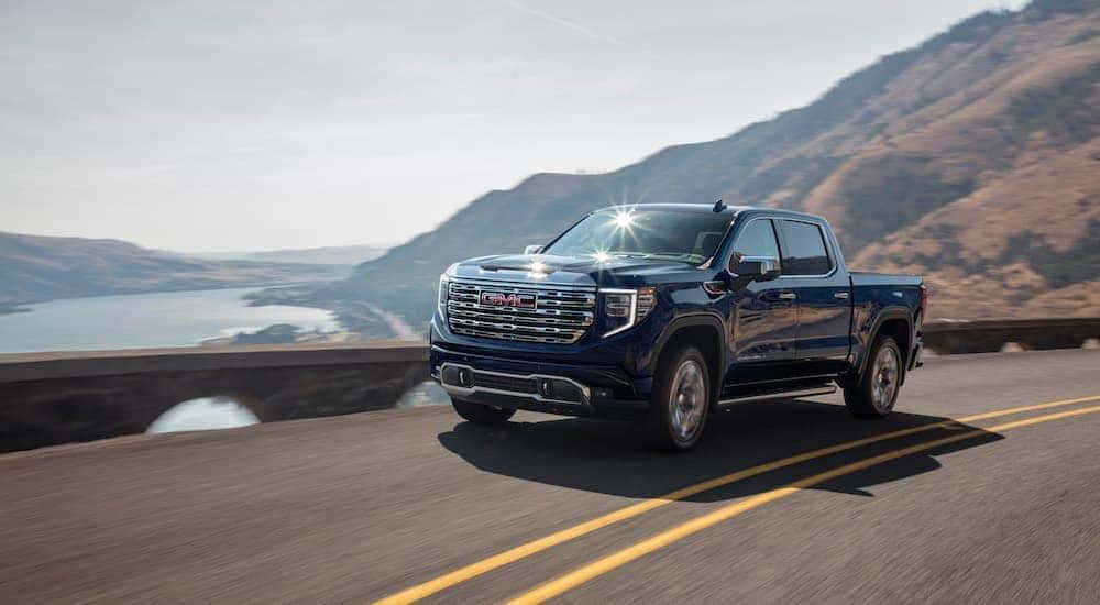 A black 2024 GMC Sierra 1500 Denali is shown from the front at an angle.