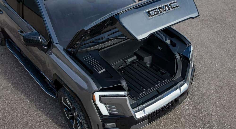 The frunk is shown open on a silver 2025 GMC Sierra EV Denali.