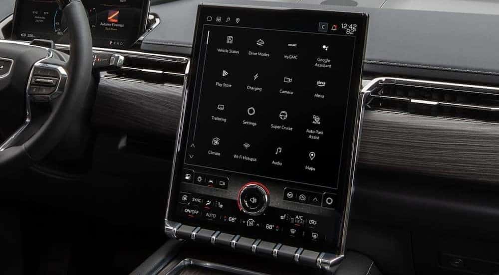 A close-up of the infotainment screen is shown in a 2025 GMC Sierra EV.