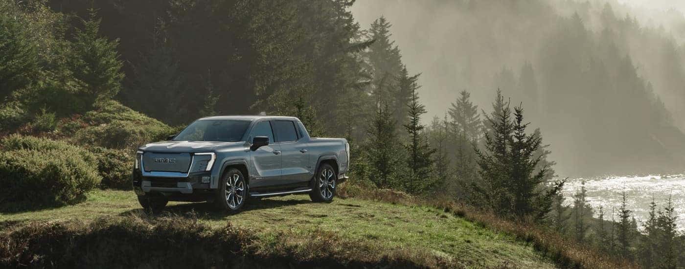 A grey 2024 GMC Sierra EV Denali Edition is shown from the front at an angle.