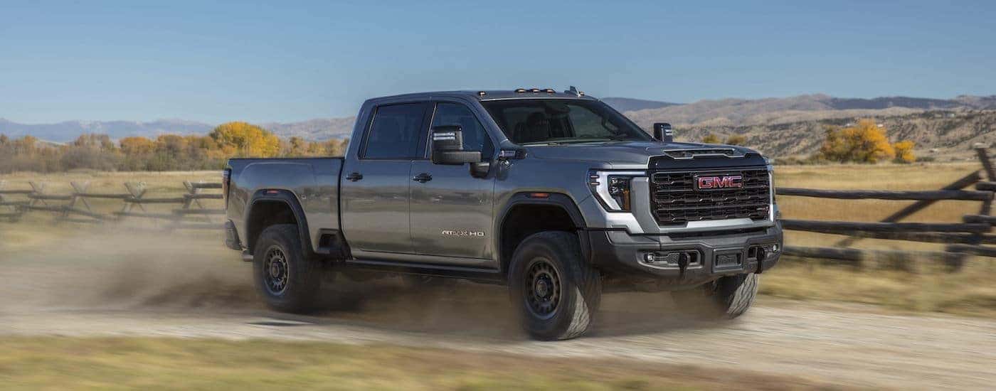 A grey 2024 GMC Sierra 2500 AT4x AEV is shown from the side.