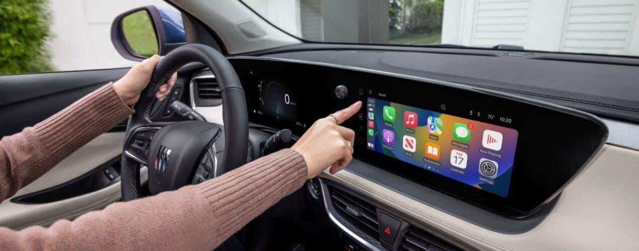 A close-up shows the infotainment screen in a 2025 Buick Encore GX ST.