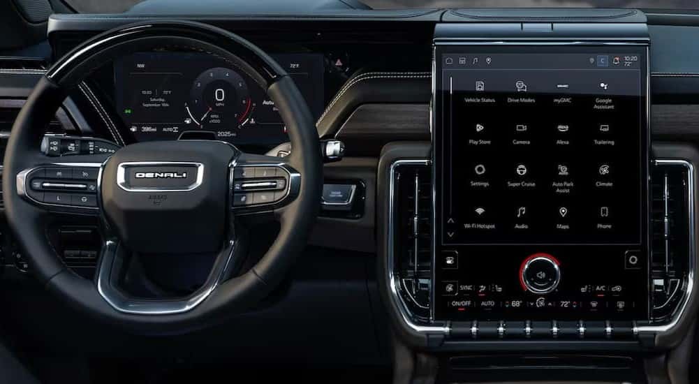 The steering wheel and infotainment screen are shown in a 2025 GMC Yukon XL for sale.
