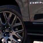 A close-up of the wheel is shown on a 2025 GMC Yukon XL Denali.