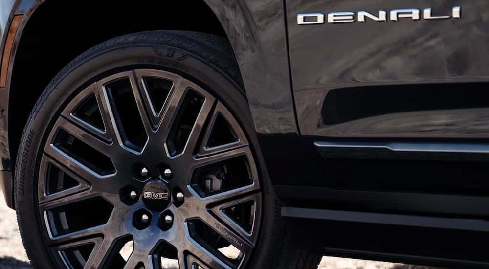 A close-up of the wheel is shown on a 2025 GMC Yukon XL Denali.