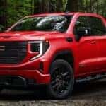 A red 2025 Sierra 1500 Elevation is shown parked after visiting a GMC dealer near Gainesville.