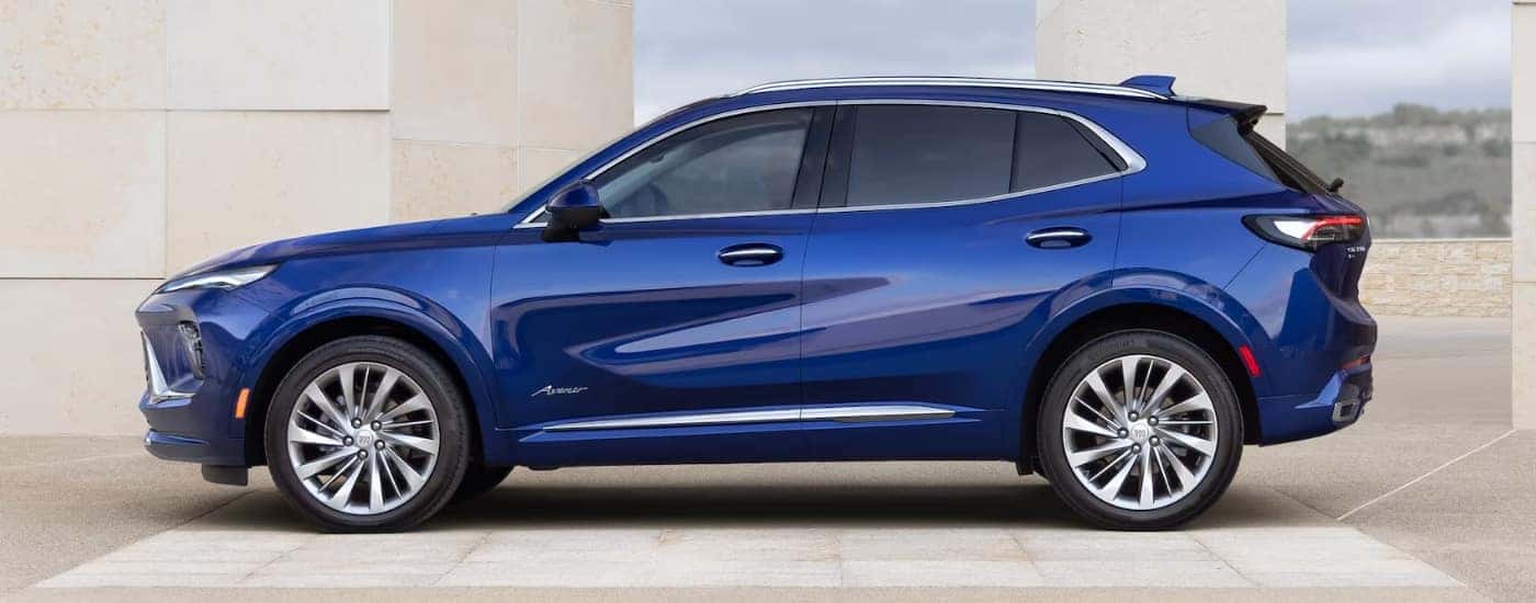 A blue 2025 Buick Envision Avenir parked on a cloudy day.
