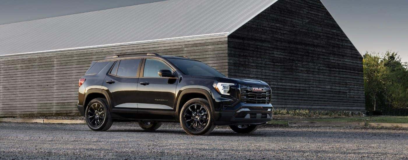 A black 2025 GMC Terrain from the side after leaving a GMC dealer near Lawrenceville.
