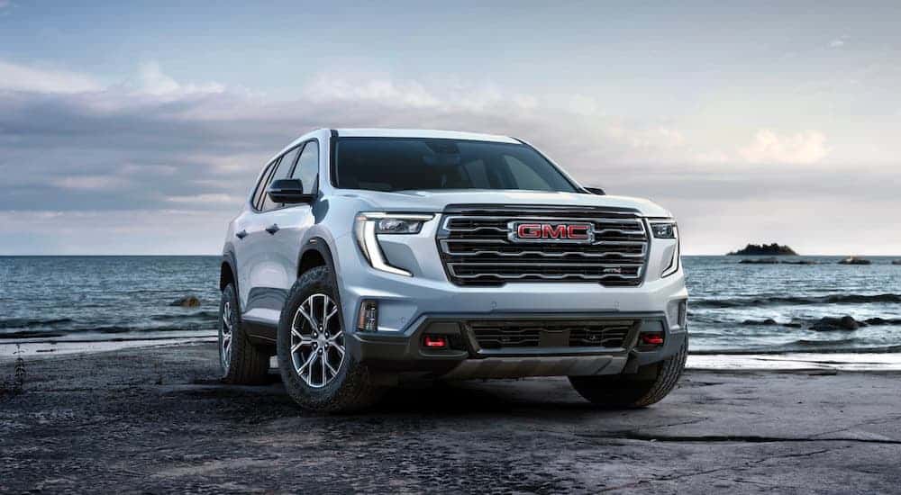 A white 2025 GMC Acadia from the front.