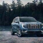 A blue 2025 GMC Acadia from the front after leaving a GMC dealer near Lawrenceville.