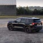 A black 2025 GMC Terrain from the side after leaving a GMC dealer near Alpharetta.