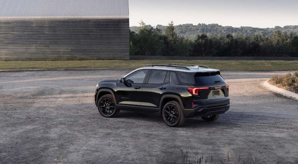 A black 2025 GMC Terrain from the side after leaving a GMC dealer near Alpharetta.