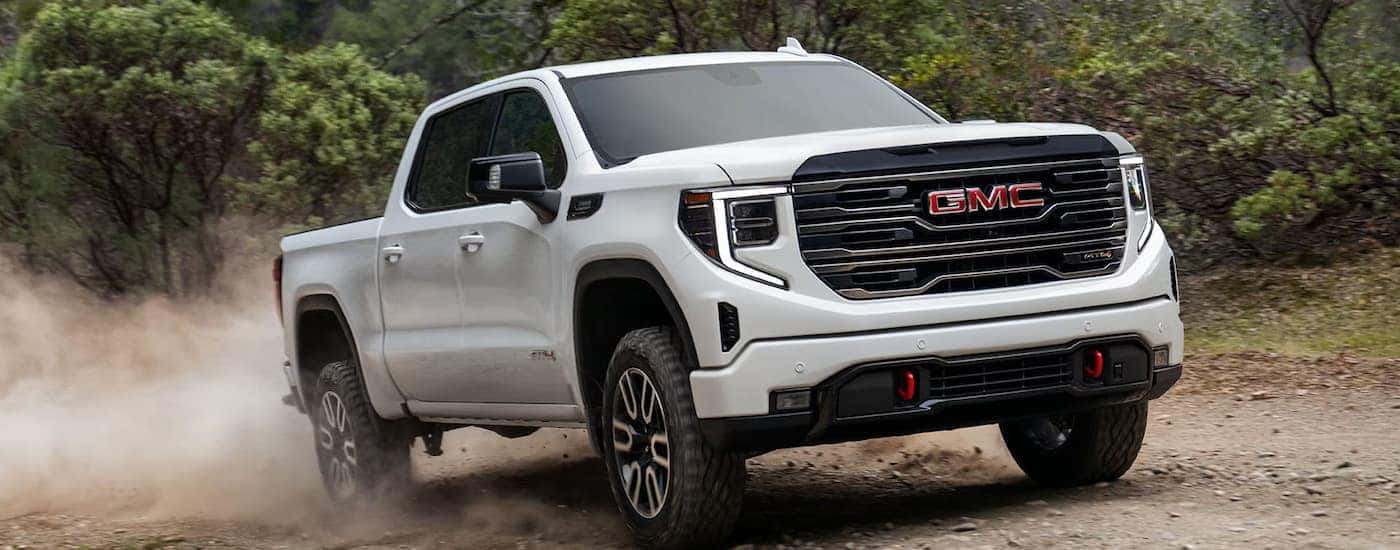 A white 2025 GMC Sierra 1500 AT4 off-roading