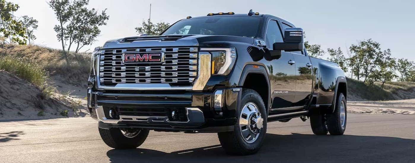 A black 2025 GMC Sierra 2500 HD Denali parked off-road.