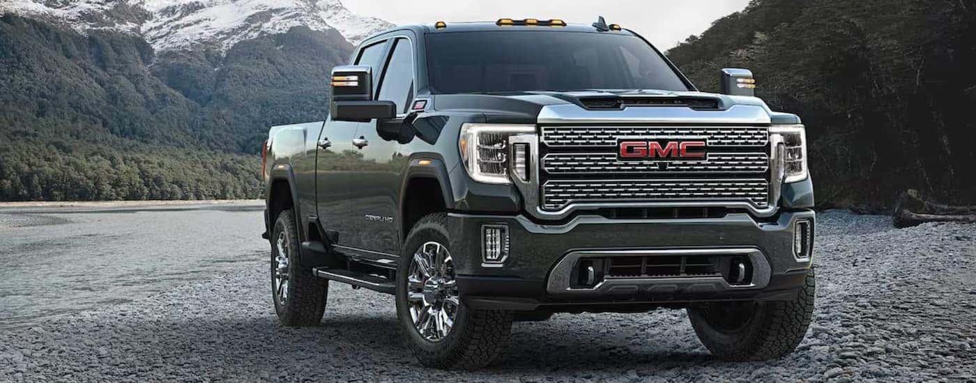 Dark green 2023 GMC Sierra 2500 HD parked off-road.
