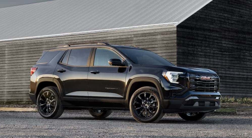 A black 2025 GMC Terrain Elevation parked near a house.