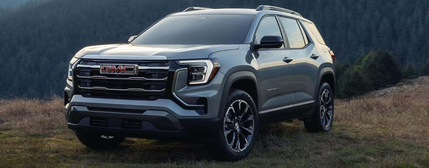 A silver 2025 GMC Terrain Elevation Premium parked on grass.