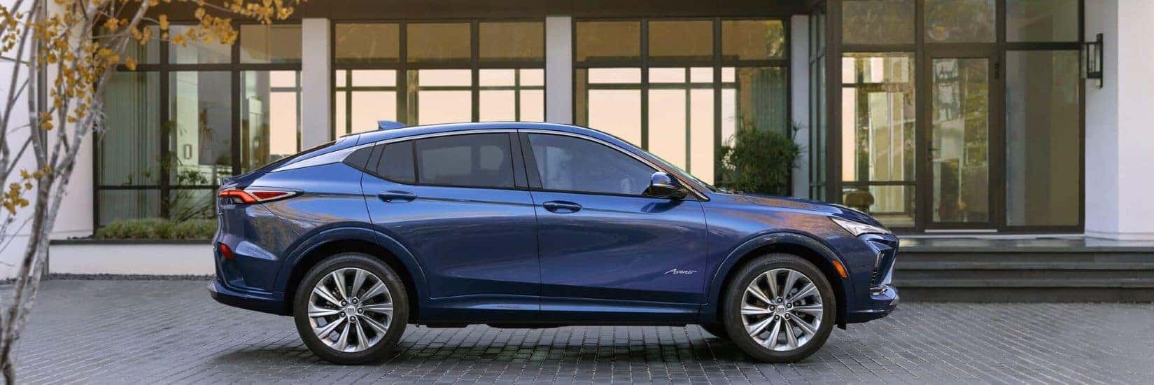 A blue 2024 Buick Envista Avenir is shown parked near a house after visiting a Buick dealer near Gainesville.