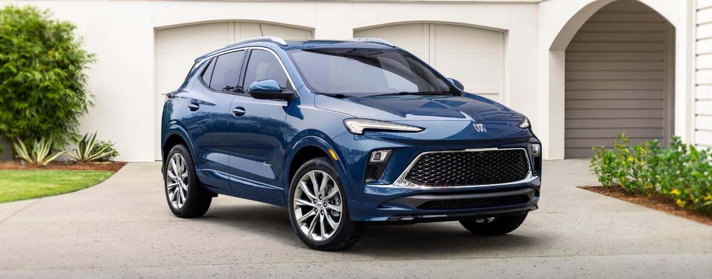 Popular Buick SUVs for sale, a blue 2024 Buick Encore GX, is shown parked on a driveway.
