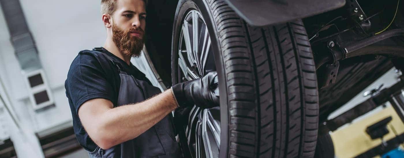 Technician installing a tire at a Buick service center near Ridgewood
