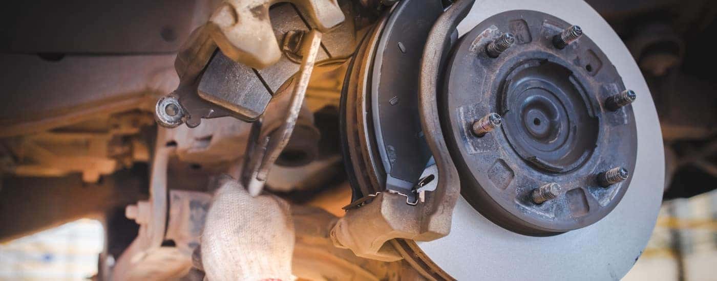 Technician using a clamp on a brake pad