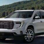A white 2026 GMC Acadia parked outdoors.