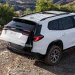Rear view of a White 2026 GMC Acadia for sale with the tailgate opening.